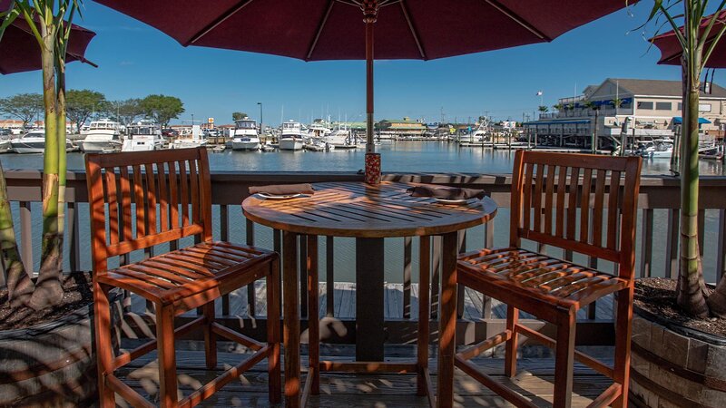 Patio dining high top table looking over open water