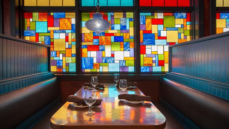 Indoor dining booth with stain glass window